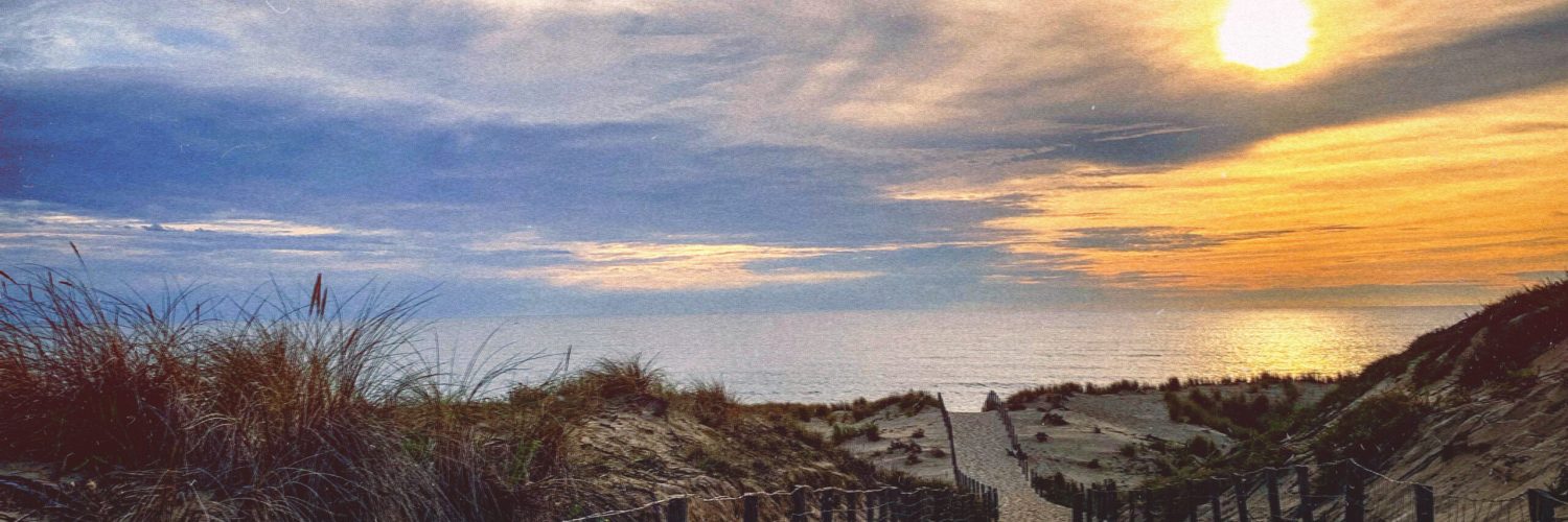 Scenic View Of Beach Against Sky During Sunset