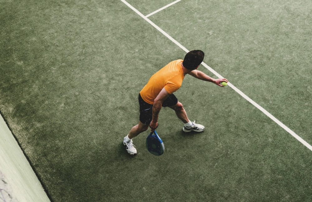 Aerial view of a padel tennis player ready to serve